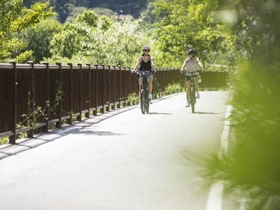 Cyclists ride on the Algund cycle path